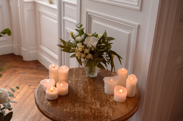 Close up of white flowers roses bouquet candles